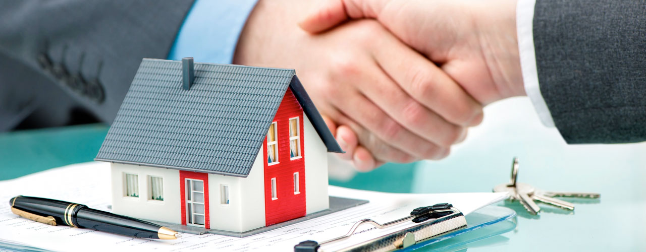 A property transaction represented by a home and a handshake
